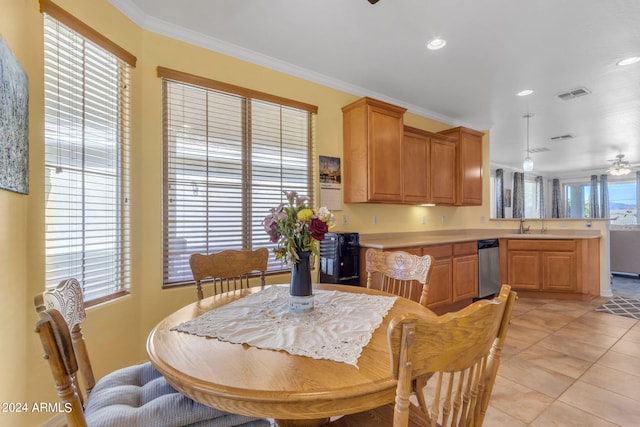 tiled dining area featuring ceiling fan, crown molding, and sink