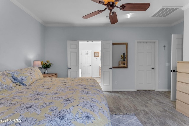 bedroom featuring ceiling fan, crown molding, and light wood-type flooring