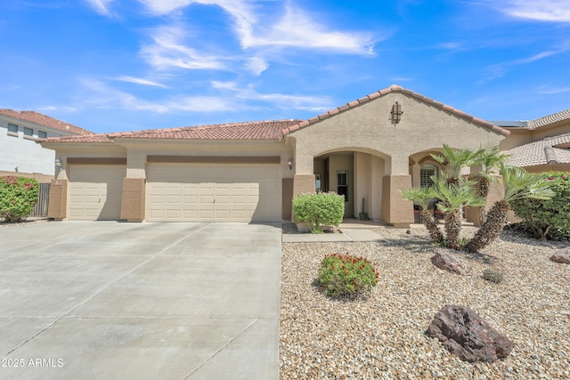 209 N 237th Ave, Buckeye, AZ 85396 - mediterranean / spanish-style home with stucco siding, an attached garage, driveway, and a tiled roof