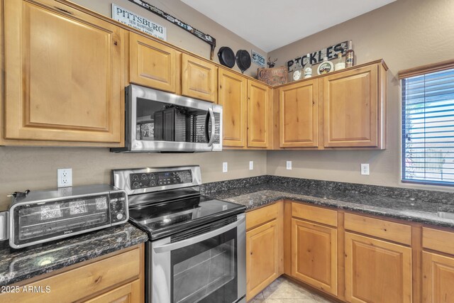 209 N 237th Ave, Buckeye, AZ 85396 - kitchen with stainless steel appliances and dark stone counters