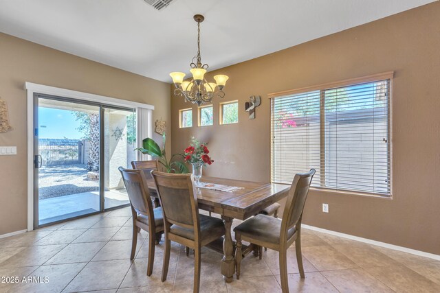 209 N 237th Ave, Buckeye, AZ 85396 - dining room with a chandelier, baseboards, and light tile patterned flooring