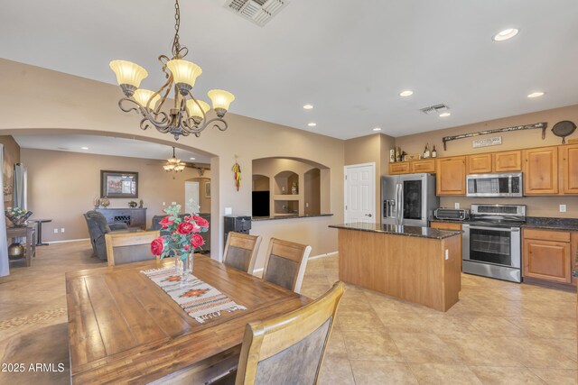 209 N 237th Ave, Buckeye, AZ 85396 - dining area featuring arched walkways, a chandelier, recessed lighting, light tile patterned floors, and baseboards