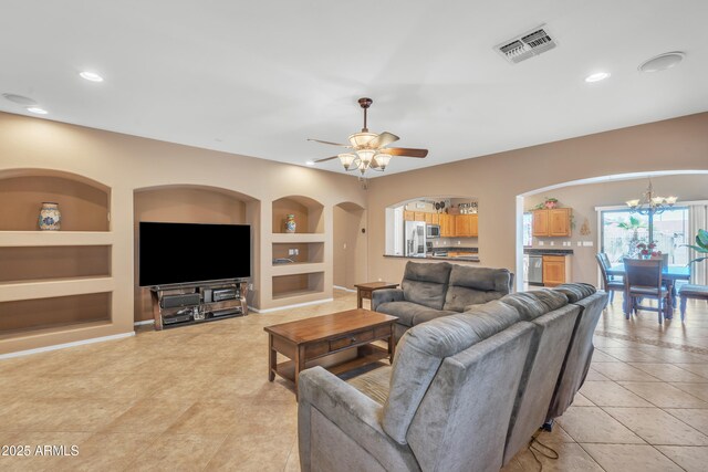 209 N 237th Ave, Buckeye, AZ 85396 - living room with built in features, a chandelier, light tile patterned floors, recessed lighting, and ceiling fan