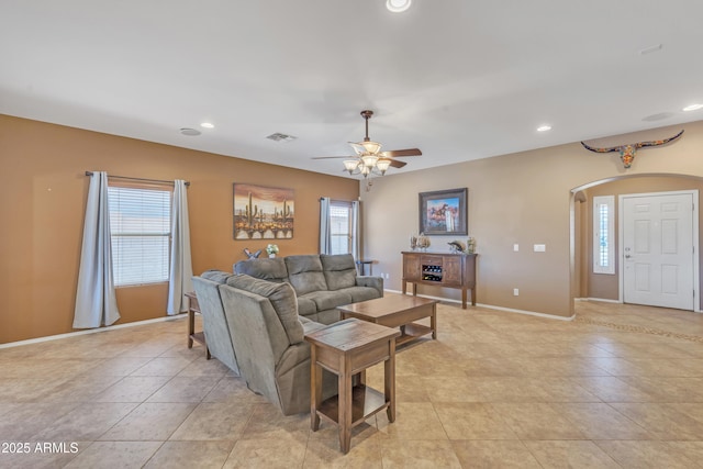 209 N 237th Ave, Buckeye, AZ 85396 - living room with arched walkways, a ceiling fan, recessed lighting, baseboards, and light tile patterned floors