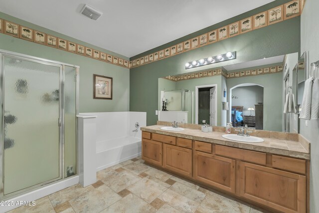 209 N 237th Ave, Buckeye, AZ 85396 - bathroom with a stall shower, a bath, and stone finish flooring