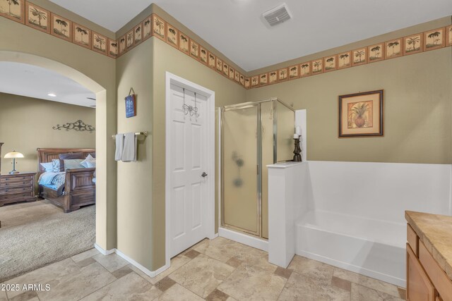 209 N 237th Ave, Buckeye, AZ 85396 - bathroom with a shower stall, a bath, ensuite bathroom, and stone finish floors