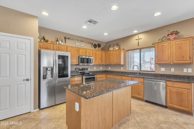 209 N 237th Ave, Buckeye, AZ 85396 - kitchen with appliances with stainless steel finishes, a sink, dark stone countertops, recessed lighting, and a kitchen island