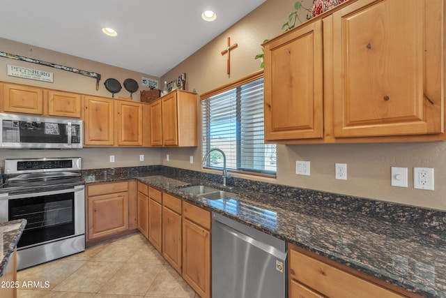 209 N 237th Ave, Buckeye, AZ 85396 - kitchen featuring stainless steel appliances, a sink, light tile patterned floors, dark stone counters, and recessed lighting