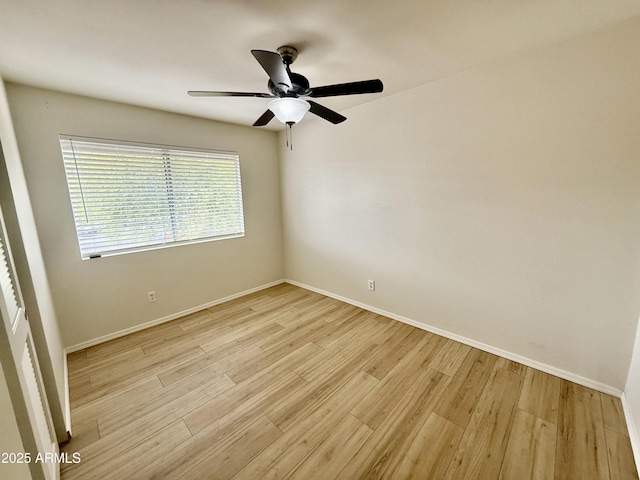 unfurnished room featuring ceiling fan, light wood-style flooring, and baseboards