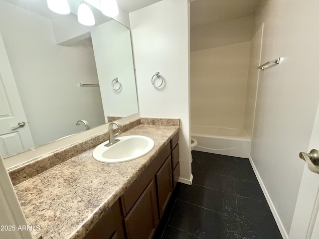 bathroom with vanity, toilet, tile patterned flooring, and baseboards