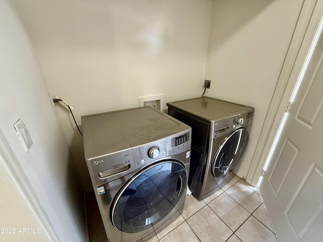 laundry area featuring light tile patterned flooring, independent washer and dryer, and laundry area