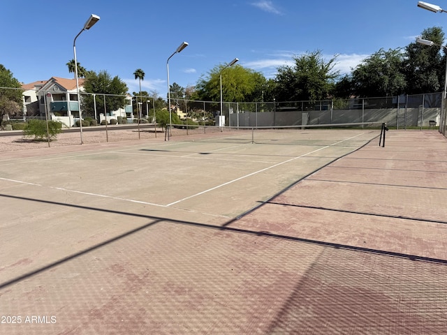 view of sport court featuring fence