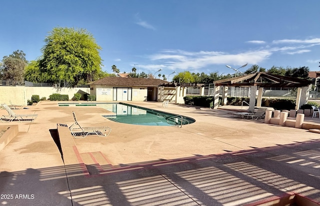community pool featuring fence, a gazebo, and a patio area