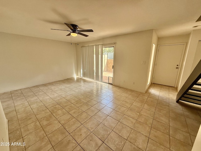 spare room with light tile patterned floors and a ceiling fan