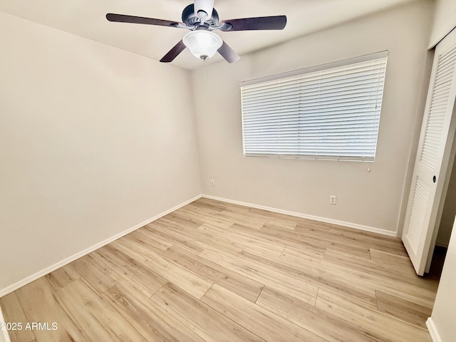 unfurnished bedroom with ceiling fan, light wood-type flooring, baseboards, and a closet