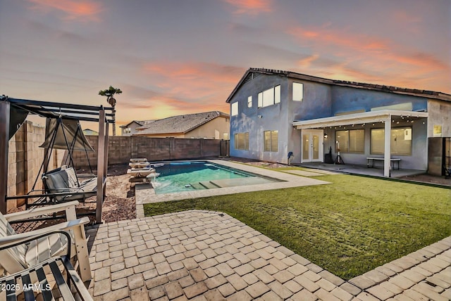 view of pool with a yard, a patio, a fenced in pool, and a fenced backyard
