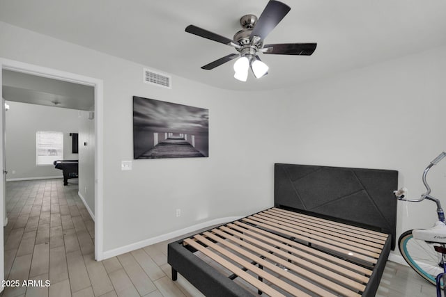 bedroom featuring a ceiling fan, baseboards, pool table, wood finished floors, and visible vents