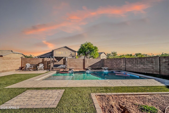 view of pool featuring a fenced backyard, a fenced in pool, a yard, and a patio area
