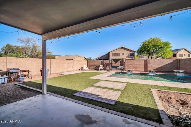 view of yard with a fenced in pool, a fenced backyard, and a patio area