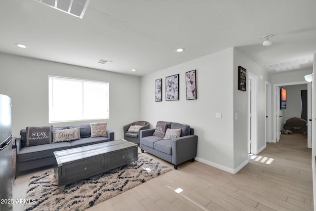 living room featuring visible vents, recessed lighting, and light wood finished floors