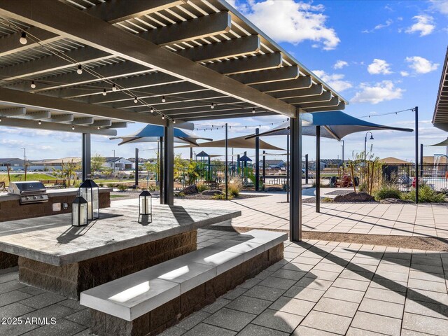 17595 W Monroe St, Goodyear, AZ 85338 - view of patio / terrace with a pergola and an outdoor kitchen