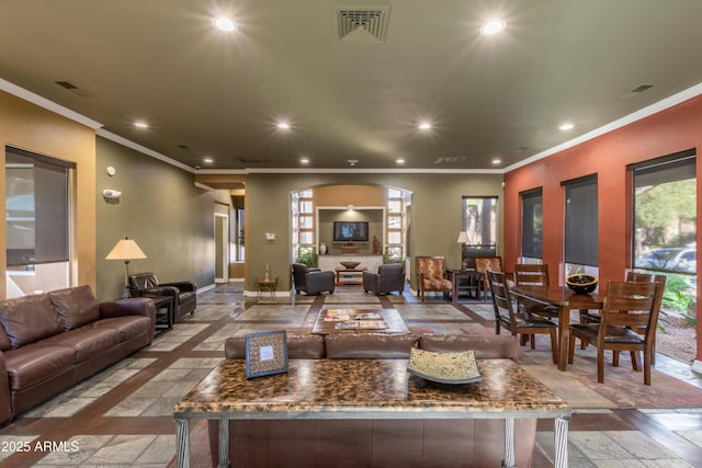 living room featuring recessed lighting, ornamental molding, baseboards, and visible vents