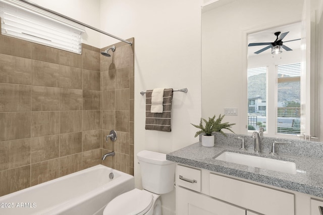 bathroom featuring  shower combination, vanity, toilet, and a ceiling fan