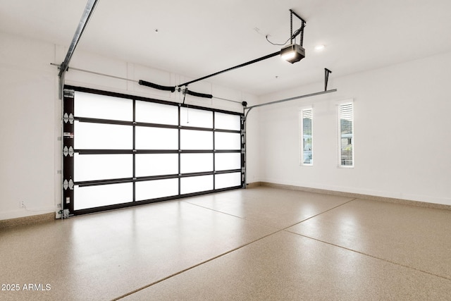 garage with baseboards and a garage door opener