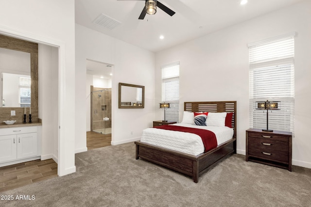 bedroom with baseboards, visible vents, connected bathroom, light colored carpet, and recessed lighting