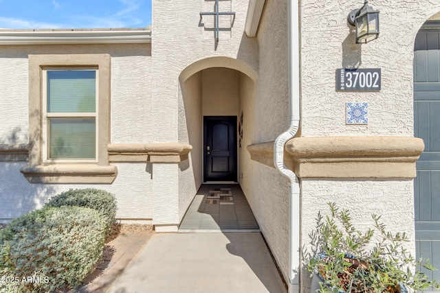 property entrance featuring stucco siding