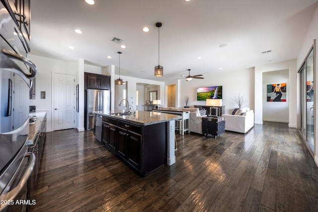 7432 W Bronco Trl, Peoria, AZ 85383 - kitchen with a sink, appliances with stainless steel finishes, open floor plan, dark wood-style floors, and a ceiling fan