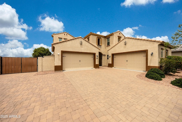 7432 W Bronco Trl, Peoria, AZ 85383 - mediterranean / spanish-style home with an attached garage, stucco siding, and driveway