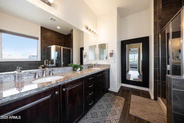7432 W Bronco Trl, Peoria, AZ 85383 - bathroom featuring double vanity, a stall shower, healthy amount of natural light, and tile patterned flooring