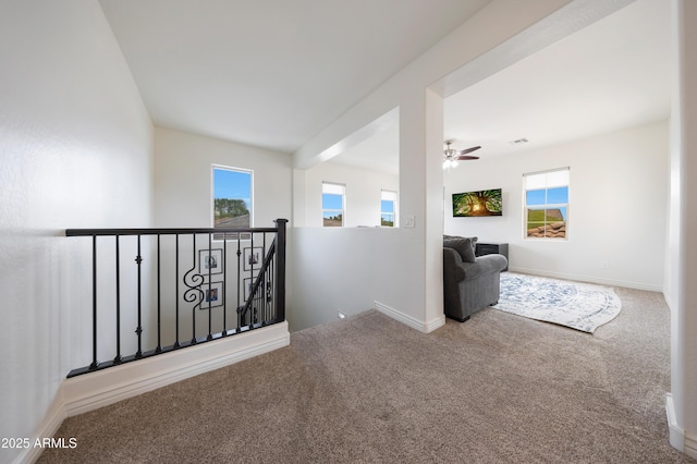 7432 W Bronco Trl, Peoria, AZ 85383 - hallway with carpet flooring, an upstairs landing, plenty of natural light, and baseboards