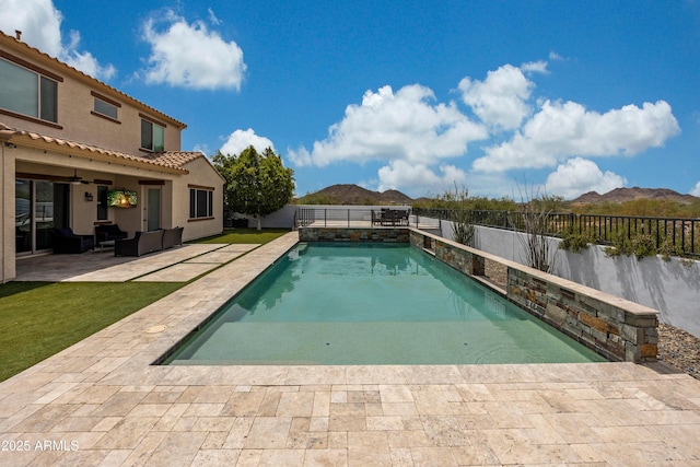 7432 W Bronco Trl, Peoria, AZ 85383 - view of swimming pool featuring a patio, a fenced backyard, outdoor lounge area, ceiling fan, and a mountain view