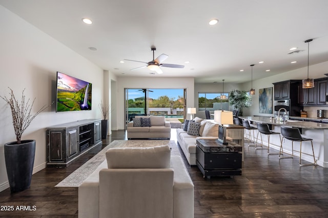 7432 W Bronco Trl, Peoria, AZ 85383 - living room with dark wood finished floors, recessed lighting, baseboards, and ceiling fan