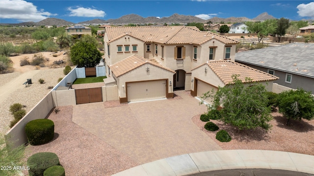 7432 W Bronco Trl, Peoria, AZ 85383 - mediterranean / spanish-style house featuring a garage, stucco siding, a tile roof, a residential view, and decorative driveway