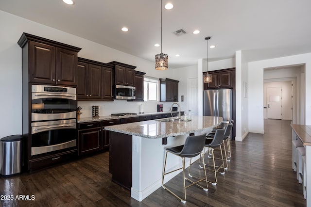 7432 W Bronco Trl, Peoria, AZ 85383 - kitchen with a sink, stainless steel appliances, dark brown cabinetry, dark wood-style floors, and recessed lighting