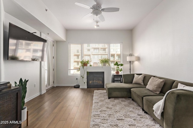 living room featuring hardwood / wood-style floors and ceiling fan