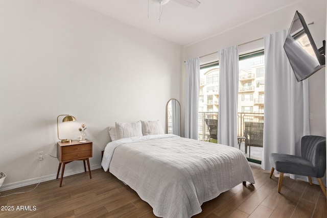 bedroom with ceiling fan, dark hardwood / wood-style floors, and access to outside