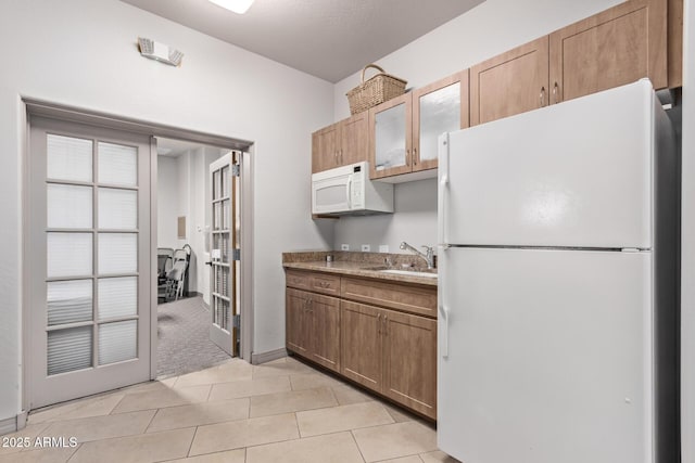 kitchen featuring light carpet, sink, and white appliances