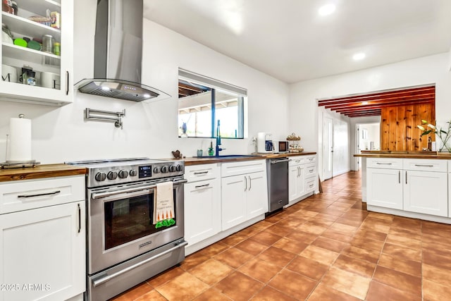 1451 E Brown Rd, Mesa, AZ 85203 - kitchen with butcher block counters, wall chimney exhaust hood, white cabinetry, a sink, and stainless steel appliances
