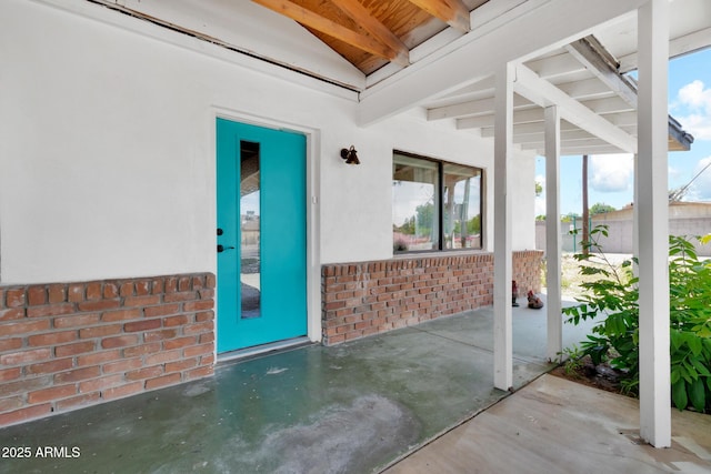 1451 E Brown Rd, Mesa, AZ 85203 - doorway to property featuring fence, a patio, stucco siding, and brick siding