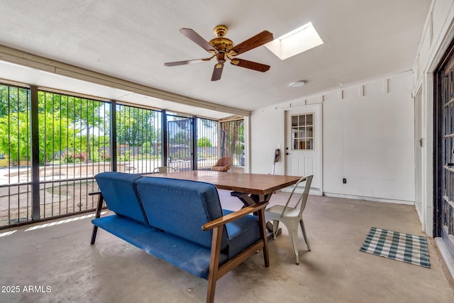 1451 E Brown Rd, Mesa, AZ 85203 - dining space with vaulted ceiling with skylight, ceiling fan, and concrete flooring