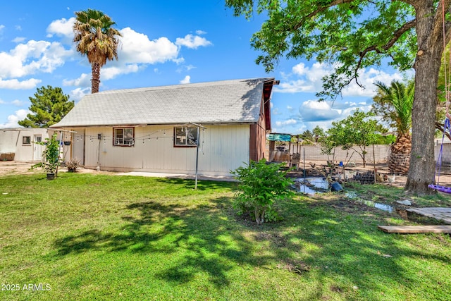 1451 E Brown Rd, Mesa, AZ 85203 - rear view of house featuring fence, a shingled roof, and a yard