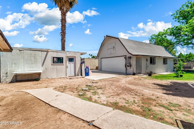 1451 E Brown Rd, Mesa, AZ 85203 - view of front of property featuring fence, a barn, a gambrel roof, a garage, and an outdoor structure