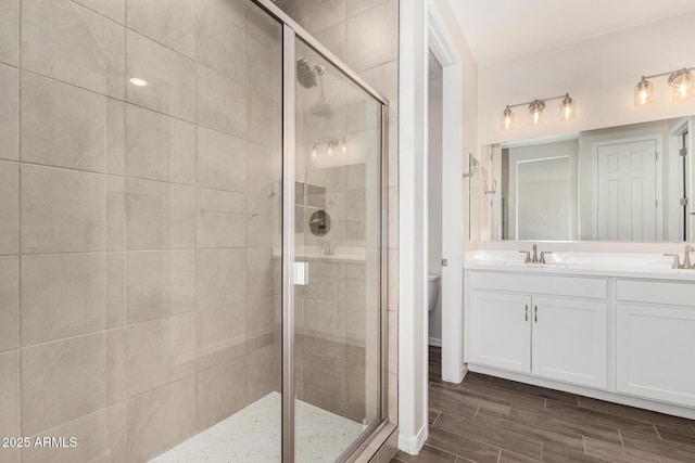 bathroom with vanity, toilet, and walk in shower