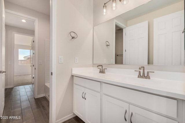 bathroom with washtub / shower combination and vanity