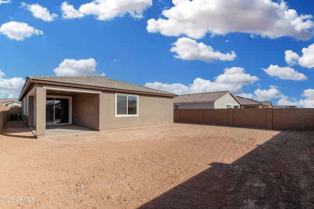 rear view of property featuring a patio area