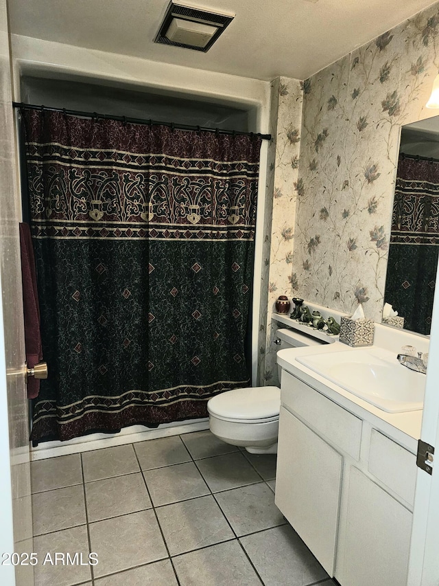 bathroom with vanity, tile patterned floors, and toilet